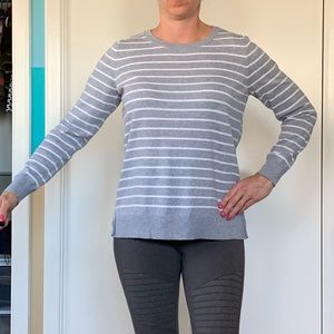 Gray/silver sweater with white strips.